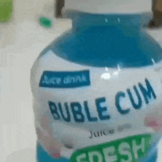 a bottle of bubble cum juice drink is sitting on a counter .