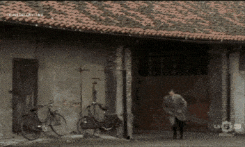 a man in a suit is running in front of a building that says la 5