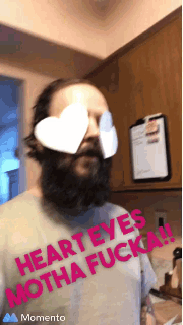 a man with a beard wearing heart shaped glasses that say heart eyes motha fucka !