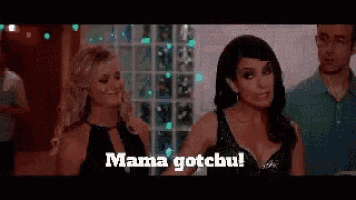 two women standing next to each other with the words mama gotchu