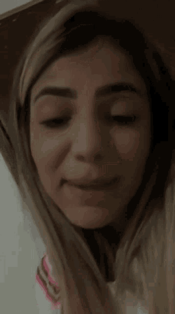 a close up of a woman 's face with a serious look on her face