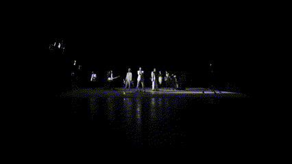 a black and white photo of a group of men singing into microphones