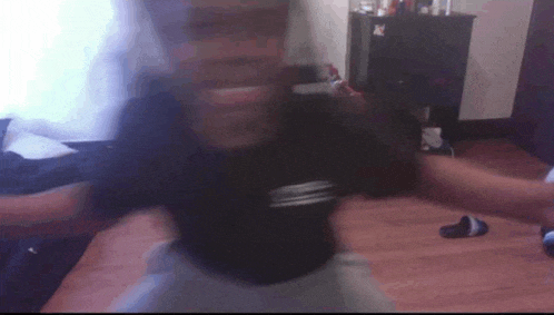 a blurry photo of a person standing on a wooden floor