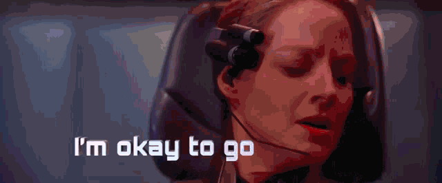 a woman wearing a headset with the words i 'm okay to go below her