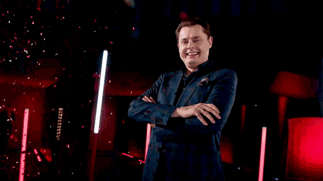 a man stands in front of a sign that says comedy on it