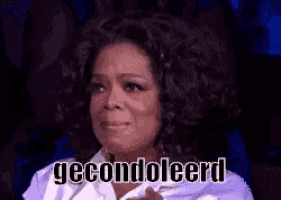 oprah winfrey is crying while wearing a white shirt and the words gecondoleerd are on the screen behind her .