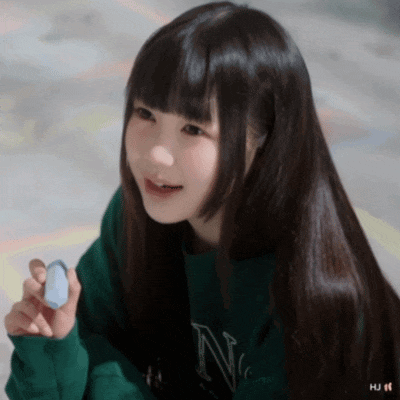 a girl in a green sweater with the letter n on it