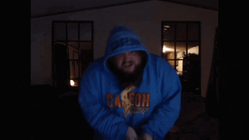a person wearing a blue hoodie with the word canyon written on it