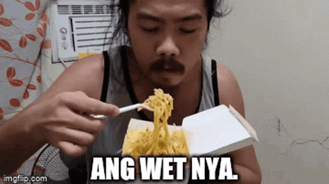 a man is eating noodles with a fork and the words ang wet nya are above him