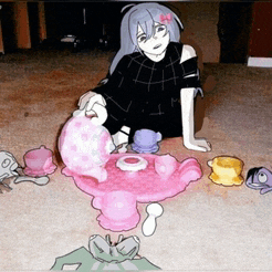 a girl is sitting on the floor playing with a pink tea set