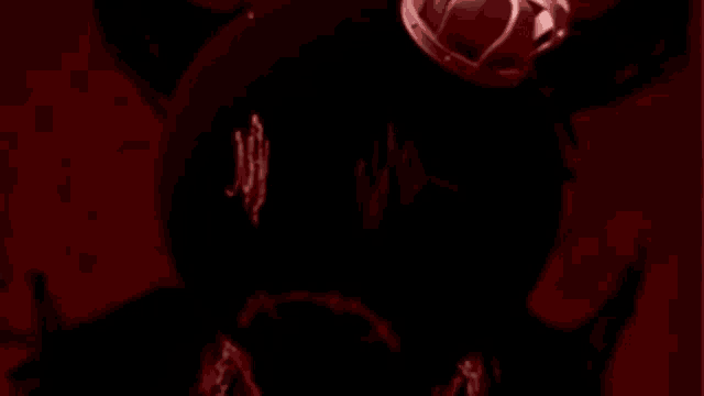 a close up of a person 's face with a crown on it in a dark room .