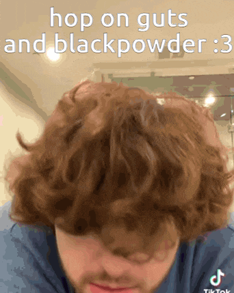 a man in a blue shirt with a caption that says hop on guts and black powder