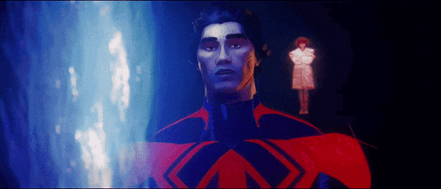 a man in a red cape is standing in front of a blue light