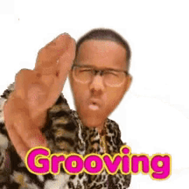a man with glasses and a leopard print shirt is grooving .