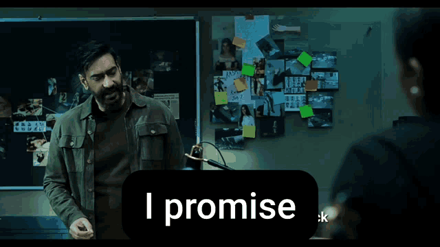 a man stands in front of a bulletin board that says i promise on it
