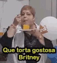 a woman is eating a piece of cake with a fork .