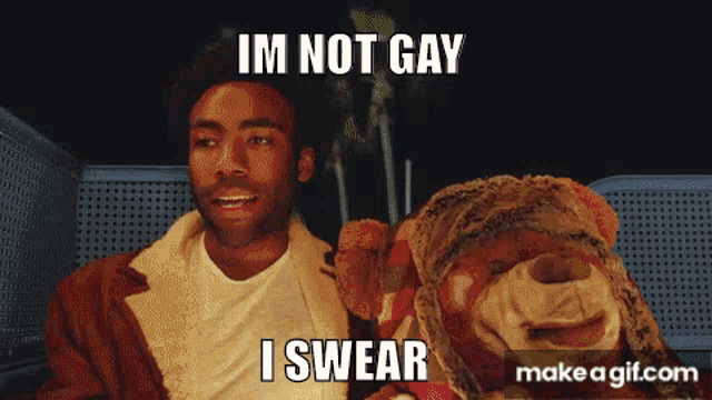 a man is holding a stuffed animal and says i 'm not gay i swear .
