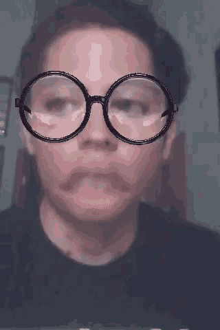 a man wearing glasses and a mustache makes a funny face .