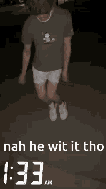 a man wearing shorts and a shirt that says nah he wit it tho on the bottom