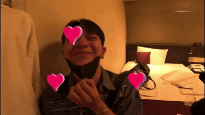 a man wearing a black mask with pink hearts on his eyes