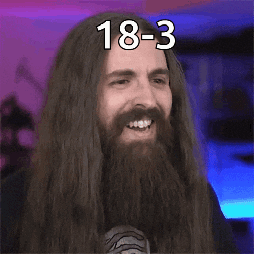a man with long hair and a beard is making a funny face and says 18-3 damn