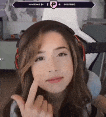 a woman wearing headphones and giving the middle finger