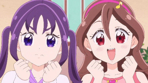 two anime girls are standing next to each other with their hands in the air