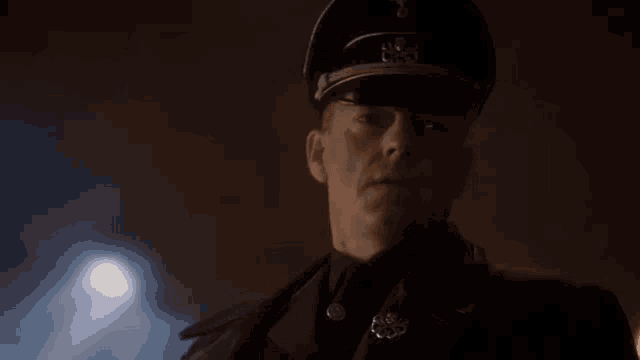 a man in a military uniform says `` i already have '' while standing in the dark .