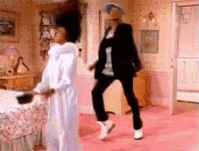 a man and woman are dancing together in a bedroom .