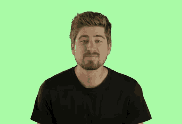 a man with a beard is blowing a kiss