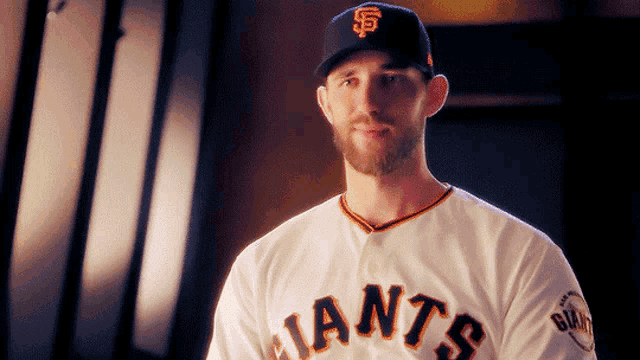 a man wearing a giants jersey and a hat