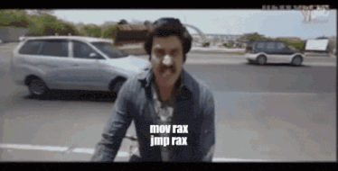 a man with a mustache says mov rax jmp rax in front of a car