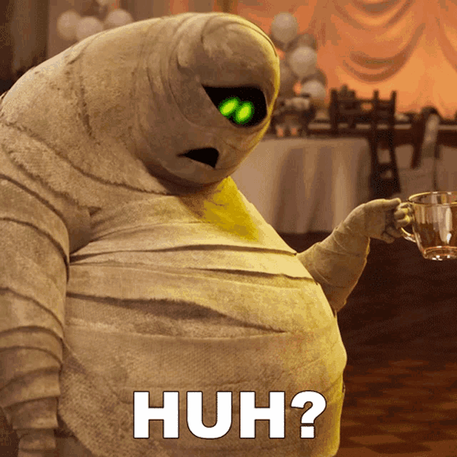 a mummy with green eyes is holding a cup of coffee and says huh ?