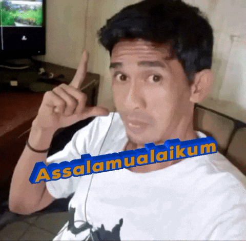 a man making a funny face with the words assalamualaikum on his shirt
