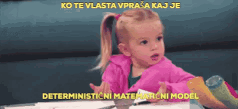 a little girl in a pink jacket is sitting at a table with the words deterministicni matematicni model above her