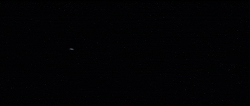 a group of space ships are flying in the dark
