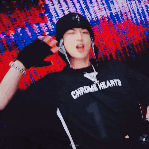 a man wearing a black shirt with the word chrome heart on it