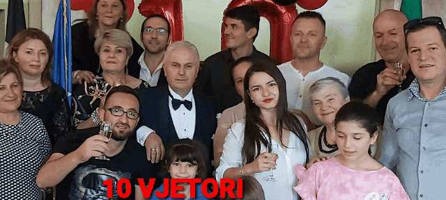 a group of people posing for a picture with the words 10 vjetori written in red