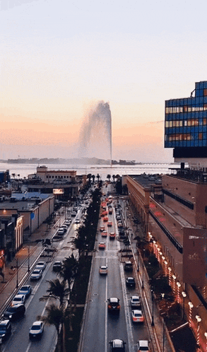 an aerial view of a busy city street with a water fountain in the background and a building that says ' bvlgari '