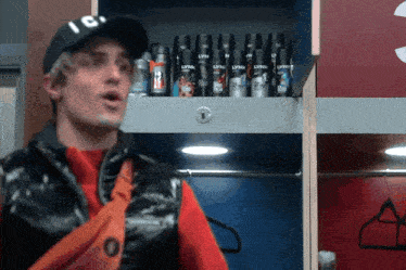 a man in a locker room with lynx deodorant on the shelves