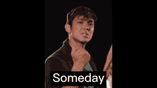 a man with a fist in the air and the word someday behind him