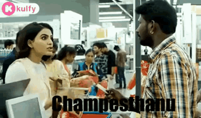 a man in a plaid shirt is talking to a woman in a store .