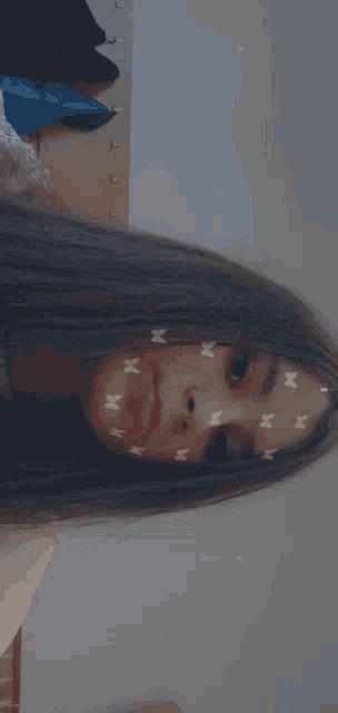 a close up of a woman 's face with butterfly stickers on her face