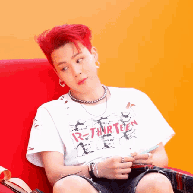 a young man with red hair is wearing a white shirt that says r-thirteen