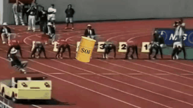 a yellow barrel that says ' oil ' on it is on a track