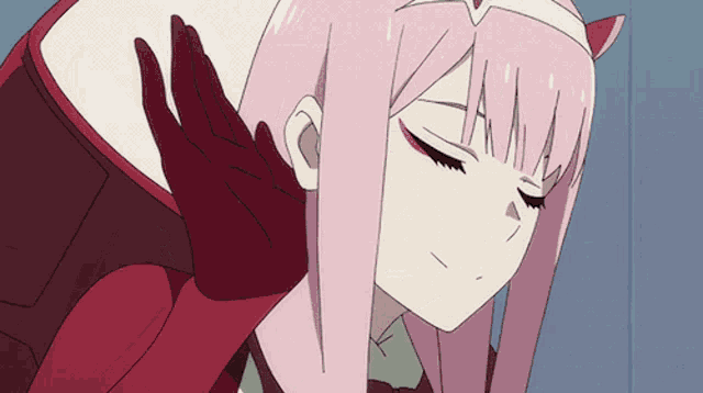 a girl with pink hair and red gloves is covering her ear with her hand