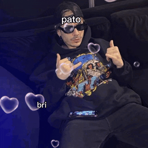 a man wearing sunglasses and a hoodie with pato on it