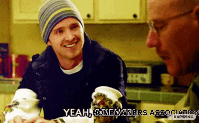 a man wearing a beanie smiles while talking to another man with the caption yeah homeowners association on the bottom