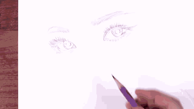 a person is drawing a face with a purple pencil