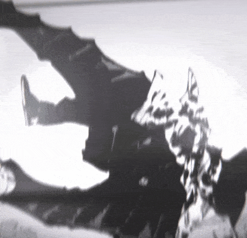 a black and white photo of a man laying on his back